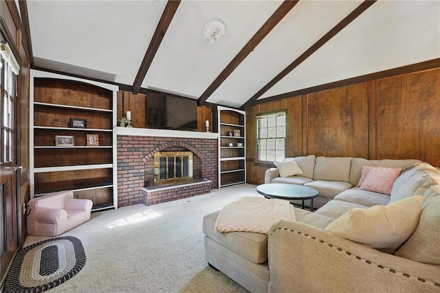 living room with beam ceiling, wood walls, carpet, built in shelves, and high vaulted ceiling