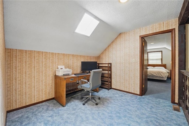 office space with vaulted ceiling, wallpapered walls, carpet floors, and a textured ceiling