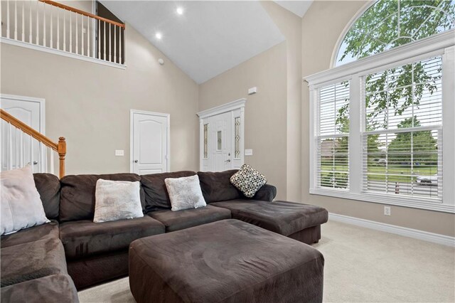 18461 W 157th St, Olathe, KS 66062 - carpeted living room with high vaulted ceiling, stairway, and recessed lighting