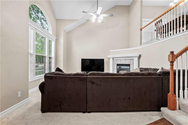 18461 W 157th St, Olathe, KS 66062 - living area with stairway, high vaulted ceiling, a tile fireplace, a ceiling fan, and carpet