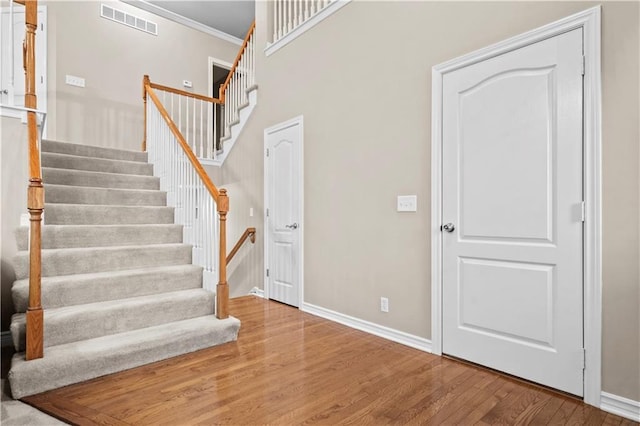 18461 W 157th St, Olathe, KS 66062 - staircase featuring wood finished floors and ornamental molding