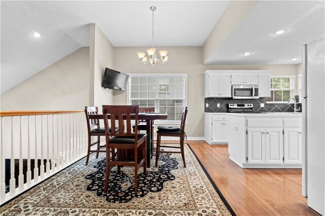 18461 W 157th St, Olathe, KS 66062 - dining room featuring light wood-type flooring, a chandelier, and recessed lighting