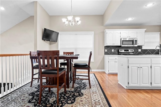 18461 W 157th St, Olathe, KS 66062 - dining area featuring light wood finished floors, a chandelier, and recessed lighting