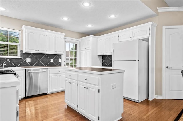 18461 W 157th St, Olathe, KS 66062 - kitchen with freestanding refrigerator, stainless steel dishwasher, light wood finished floors, tasteful backsplash, and recessed lighting