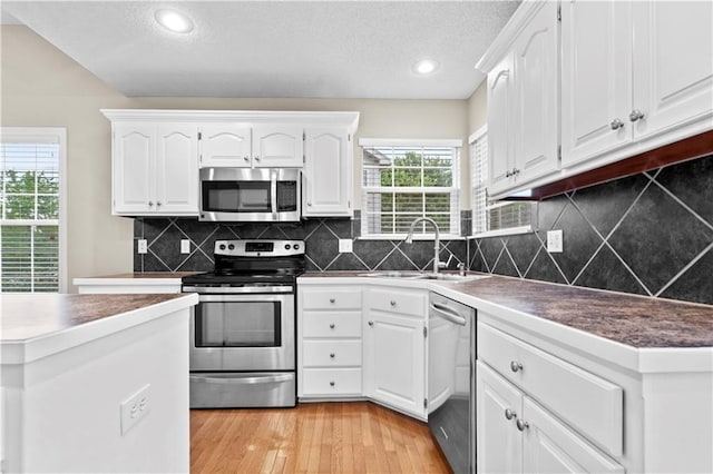 18461 W 157th St, Olathe, KS 66062 - kitchen featuring stainless steel appliances, a textured ceiling, white cabinetry, light wood-type flooring, and recessed lighting