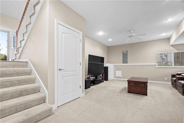 18461 W 157th St, Olathe, KS 66062 - living room featuring light carpet, a ceiling fan, recessed lighting, stairs, and electric panel