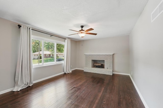 8020 Yecker Ave, Kansas City, KS 66109 - unfurnished living room featuring a ceiling fan, wood finished floors, a brick fireplace, baseboards, and a textured ceiling