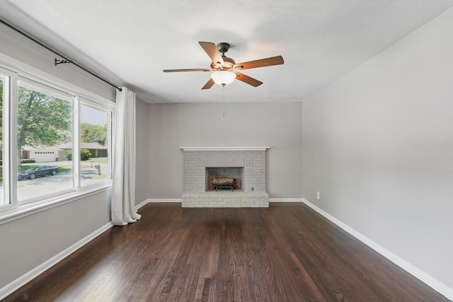 8020 Yecker Ave, Kansas City, KS 66109 - unfurnished living room with wood finished floors, ceiling fan, baseboards, and a brick fireplace