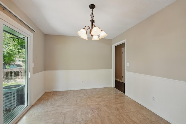 8020 Yecker Ave, Kansas City, KS 66109 - unfurnished room with a chandelier and a wainscoted wall