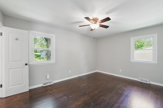 8020 Yecker Ave, Kansas City, KS 66109 - empty room with plenty of natural light, ceiling fan, wood finished floors, and baseboards