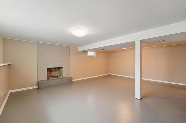 8020 Yecker Ave, Kansas City, KS 66109 - finished basement with baseboards and a brick fireplace