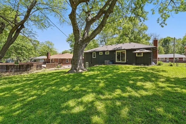 8020 Yecker Ave, Kansas City, KS 66109 - rear view of property with board and batten siding and a chimney