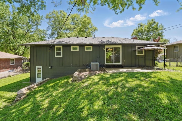 8020 Yecker Ave, Kansas City, KS 66109 - back of property featuring board and batten siding, central air condition unit, a patio, and a chimney