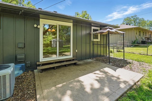 8020 Yecker Ave, Kansas City, KS 66109 - entrance to property with board and batten siding, fence, central air condition unit, and a patio