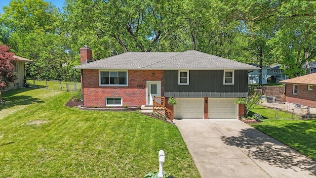 8020 Yecker Ave, Kansas City, KS 66109 - split foyer home featuring a chimney, a garage, brick siding, driveway, and roof with shingles