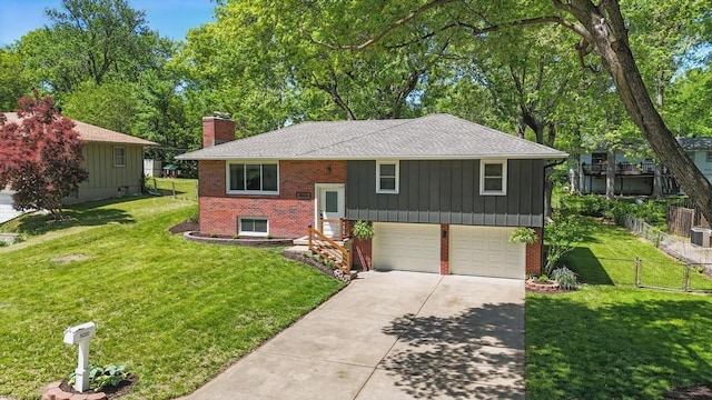 8020 Yecker Ave, Kansas City, KS 66109 - raised ranch featuring brick siding, a chimney, concrete driveway, a garage, and a shingled roof