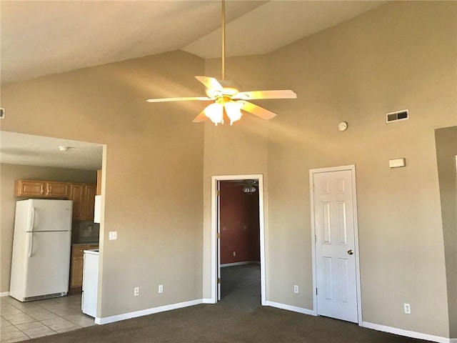 unfurnished living room featuring baseboards, visible vents, ceiling fan, and high vaulted ceiling