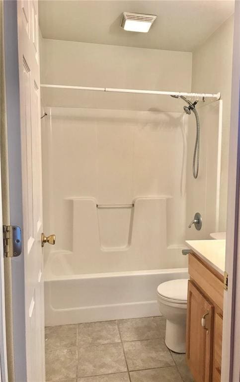 full bathroom featuring toilet, visible vents, tile patterned flooring, vanity, and washtub / shower combination