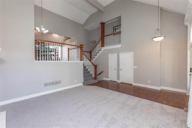 8115 NE 112th St, Kansas City, MO 64157 - unfurnished living room featuring carpet floors, high vaulted ceiling, baseboards, a chandelier, and stairs