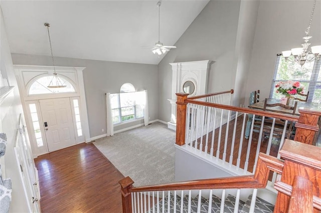 8115 NE 112th St, Kansas City, MO 64157 - entrance foyer featuring a chandelier, ceiling fan, high vaulted ceiling, baseboards, and wood finished floors