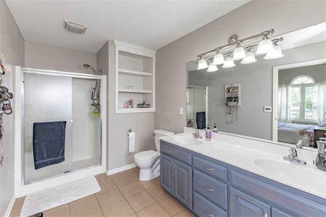 8115 NE 112th St, Kansas City, MO 64157 - bathroom with connected bathroom, a stall shower, toilet, and tile patterned floors