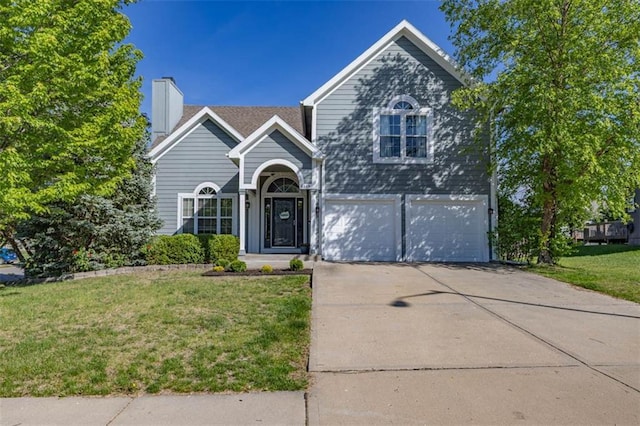 8115 NE 112th St, Kansas City, MO 64157 - traditional-style house featuring a front yard, concrete driveway, an attached garage, and a chimney