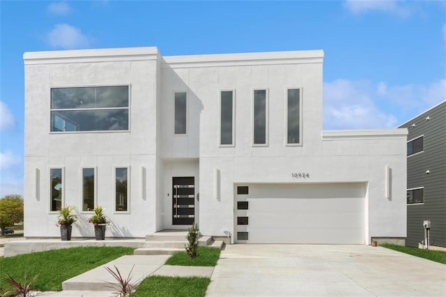 10924 W 67th St, Shawnee, KS 66203 - contemporary house featuring stucco siding, concrete driveway, and an attached garage
