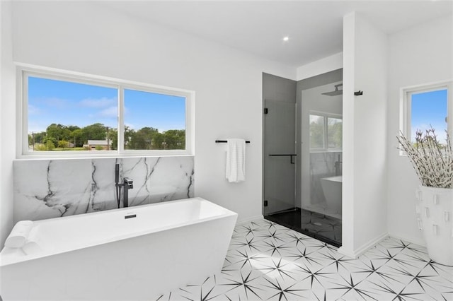 10924 W 67th St, Shawnee, KS 66203 - bathroom with a stall shower, baseboards, and a freestanding bath