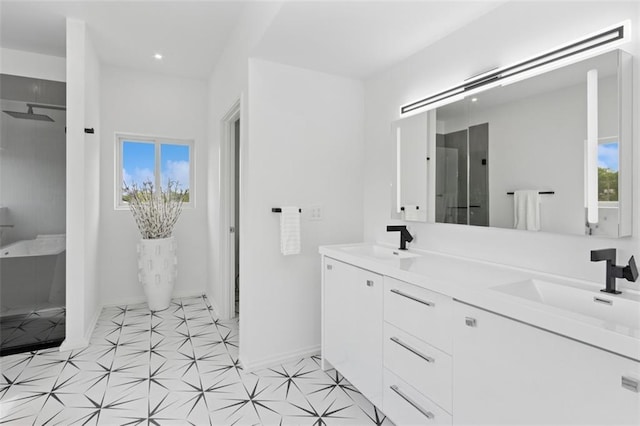 10924 W 67th St, Shawnee, KS 66203 - bathroom featuring baseboards, a shower, double vanity, and recessed lighting