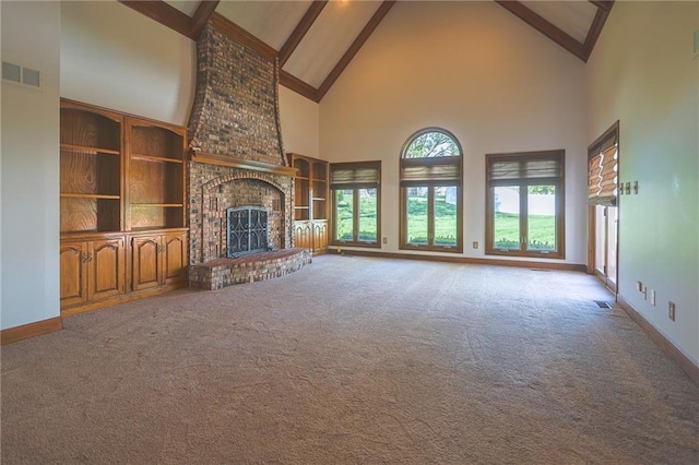 unfurnished living room featuring high vaulted ceiling, carpet flooring, a brick fireplace, beamed ceiling, and baseboards