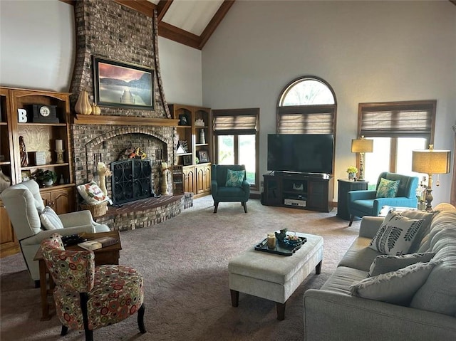 carpeted living area with high vaulted ceiling, a brick fireplace, and beam ceiling