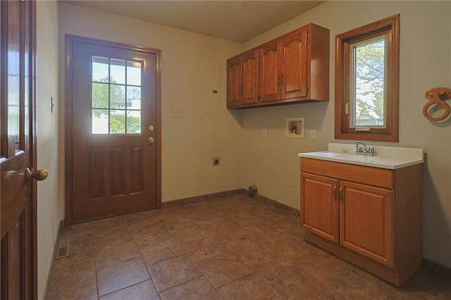 laundry area with electric dryer hookup, washer hookup, healthy amount of natural light, and cabinet space