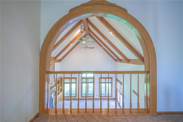 detailed view of ceiling fan, beamed ceiling, and baseboards