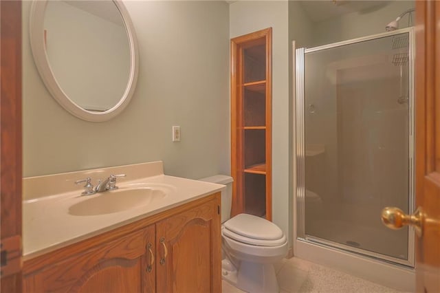 bathroom with a stall shower, vanity, toilet, and tile patterned flooring