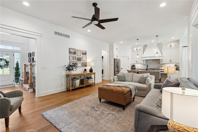 2704 W 74th St, Prairie Village, KS 66208 - living area with light wood-style floors, a ceiling fan, recessed lighting, baseboards, and washer / clothes dryer