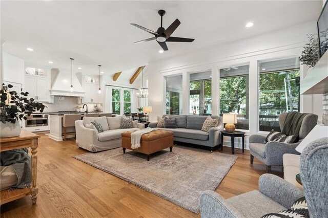 2704 W 74th St, Prairie Village, KS 66208 - living area with healthy amount of natural light, ceiling fan, light wood-type flooring, and recessed lighting