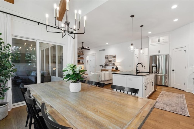 2704 W 74th St, Prairie Village, KS 66208 - dining area featuring a chandelier, wood finished floors, a ceiling fan, and recessed lighting