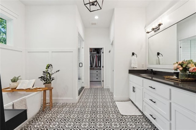 2704 W 74th St, Prairie Village, KS 66208 - full bath featuring vanity, a stall shower, a decorative wall, a freestanding bath, and a spacious closet