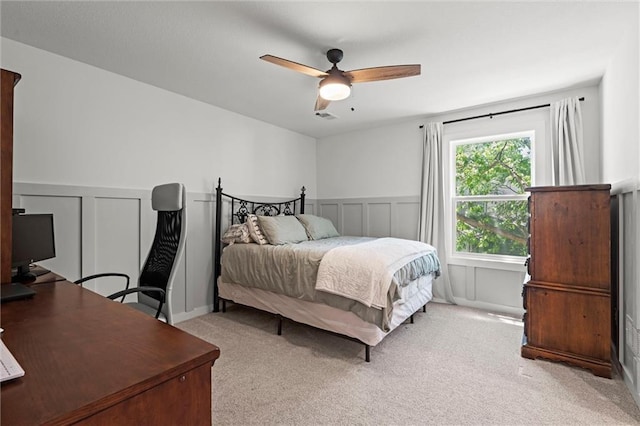 2704 W 74th St, Prairie Village, KS 66208 - bedroom featuring light carpet, a decorative wall, a desk, wainscoting, and a ceiling fan