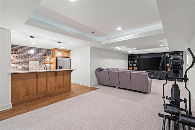 2704 W 74th St, Prairie Village, KS 66208 - living room featuring a tray ceiling, recessed lighting, light colored carpet, baseboards, and light wood-style flooring