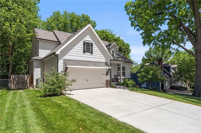 2704 W 74th St, Prairie Village, KS 66208 - traditional home featuring driveway, a shingled roof, brick siding, and a garage