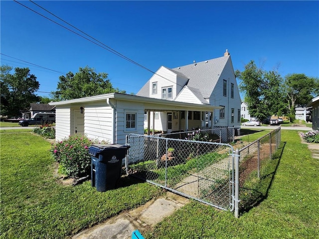 back of property featuring a yard, fence, and a porch