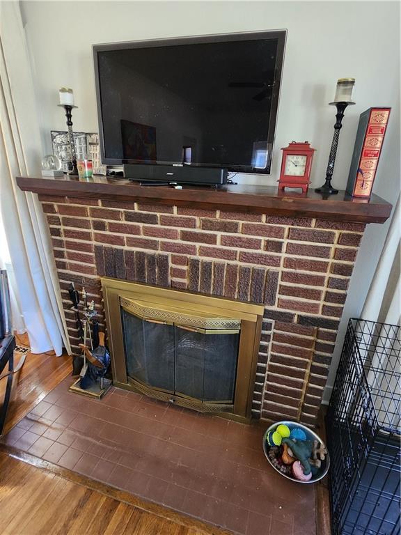 interior details with a fireplace and wood finished floors