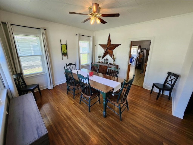 dining room with baseboards, ceiling fan, and dark wood-type flooring