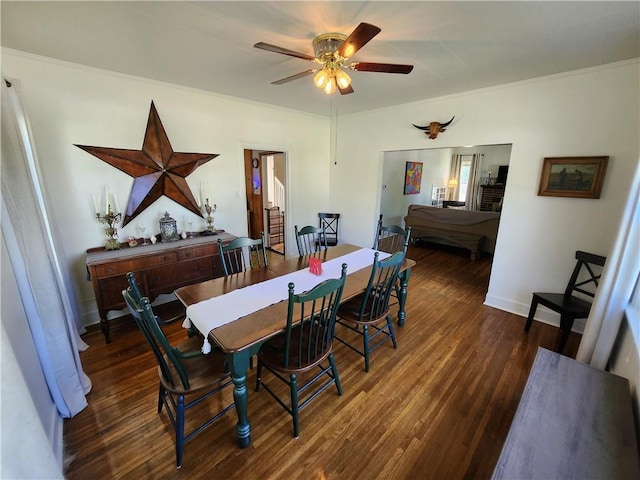 dining room featuring baseboards, ornamental molding, ceiling fan, and wood finished floors