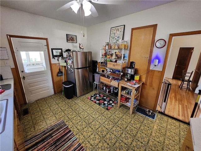 kitchen featuring freestanding refrigerator, tile patterned floors, and ceiling fan