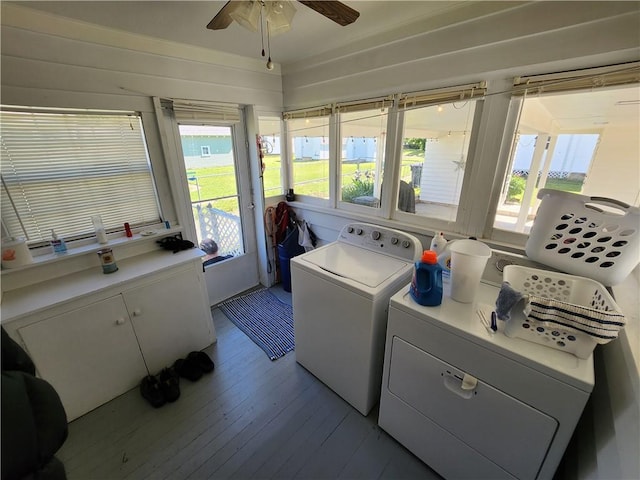 clothes washing area with laundry area, light wood-style flooring, a ceiling fan, and washing machine and clothes dryer