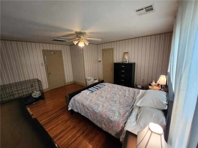 bedroom with visible vents, wood finished floors, and ceiling fan