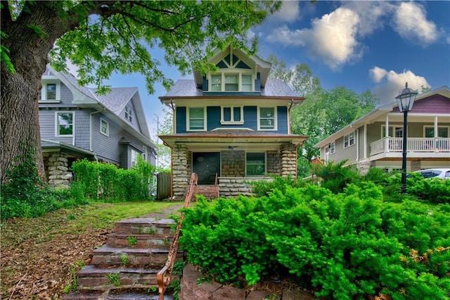 2803 Harrison St, Kansas City, MO 64109 - view of front of home featuring covered porch, stone siding, and stairs