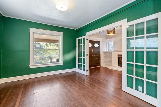 2803 Harrison St, Kansas City, MO 64109 - unfurnished room featuring wood finished floors, ornamental molding, plenty of natural light, and baseboards